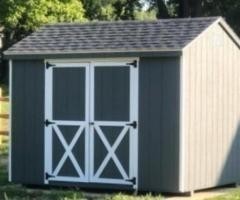 Custom shed installation with t1-11 siding and shingle roof
